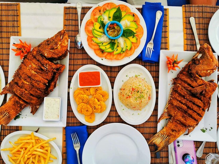 Fried fish with rice, French fries, salad and tostones