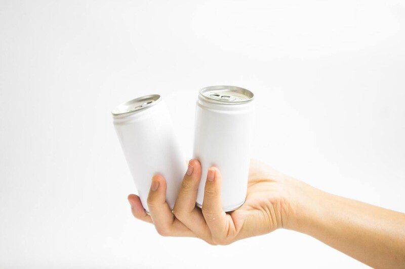 Selling aluminum cans near my location in the USA, hand with two cans