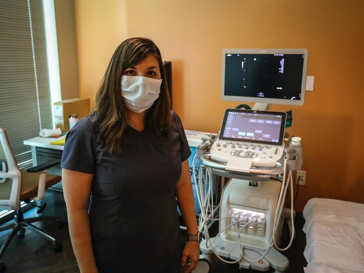 Female gynecologist with ultrasound machine