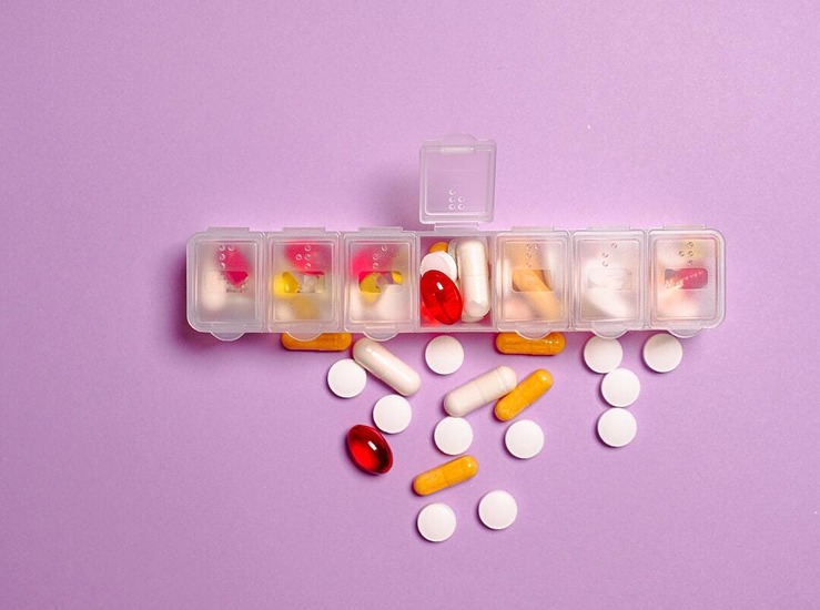 box of pills and daily vitamins